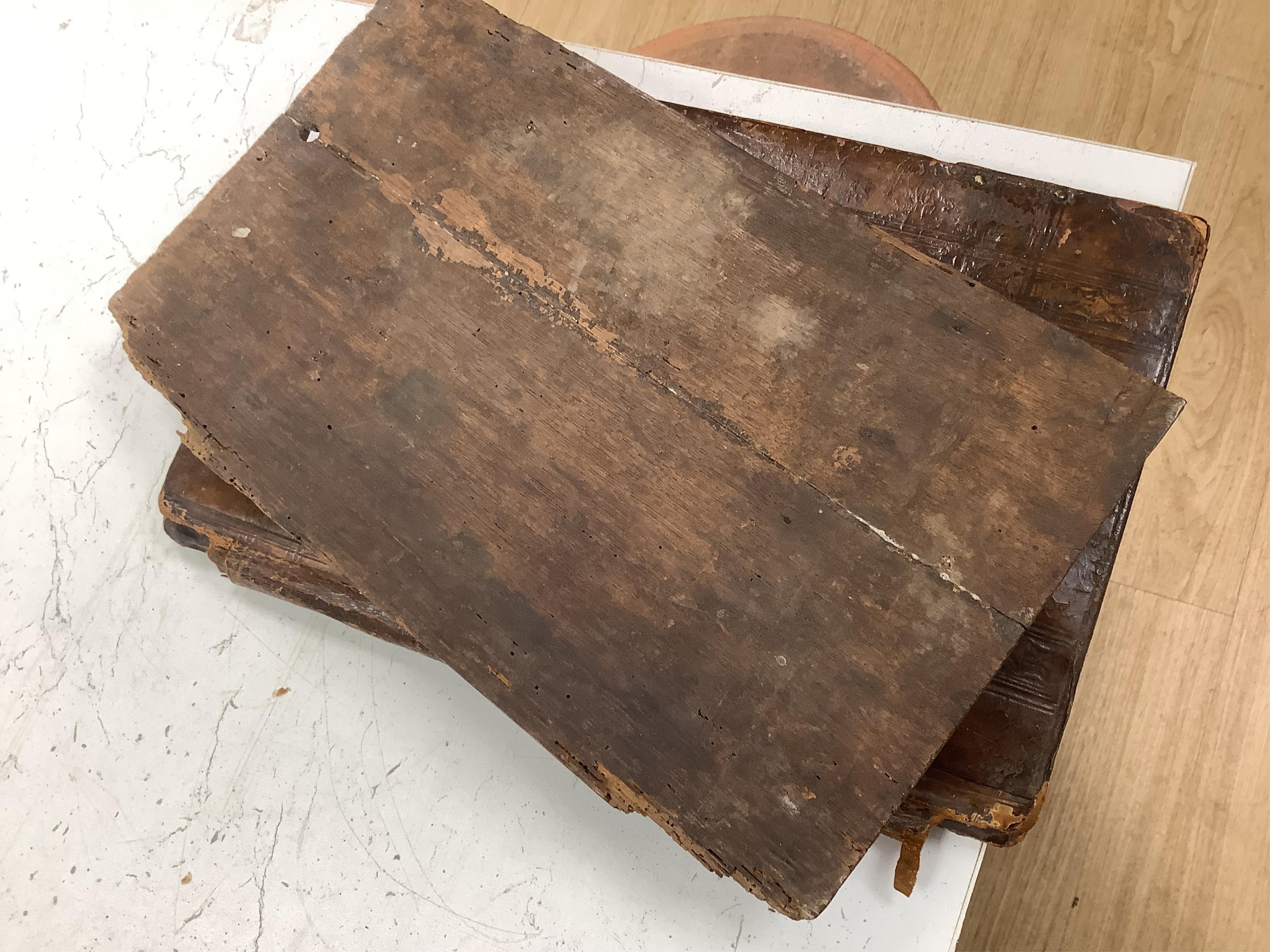 A 19th century leather binding for a book, 35cm high x 33.5cm wide, two carved gothic panels and a carved figure